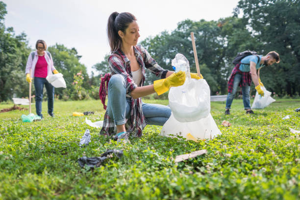 istock Woman picking up litter in the park 1153404890