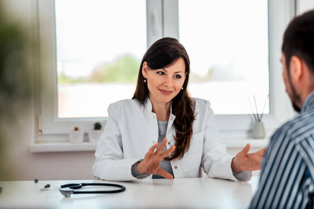 istock Portrait of a beautiful general practitioner talking and gesturing on meeting with a patient. 1153406379