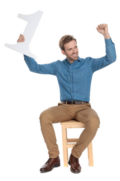 istock Joyful young man holding a number one and celebrating 1153408431