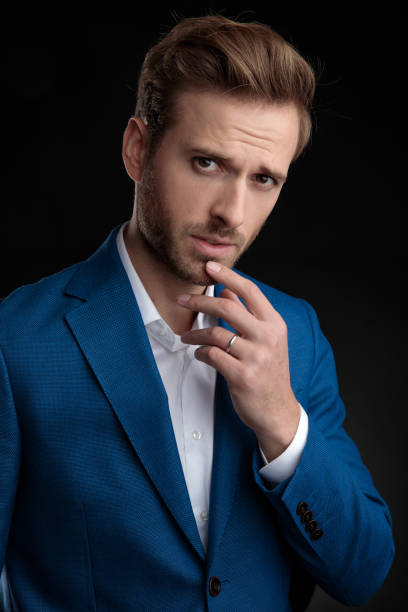 istock Suspicious man holding his hand on his chin 1153409104