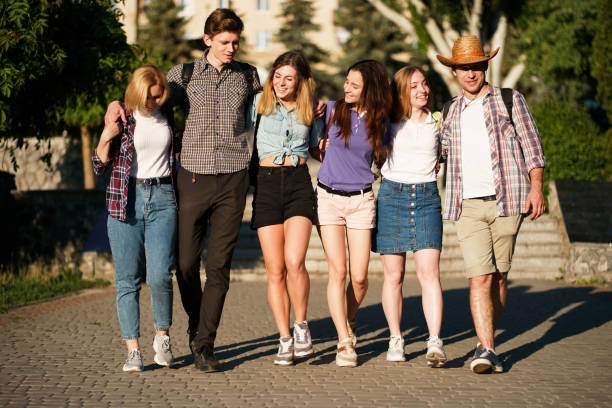 istock friends with backpacks hugging walking in the city 1153409641