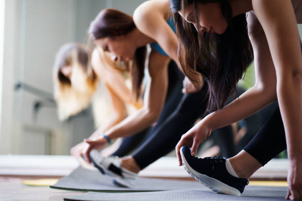 istock Women group doing stretching during yoga class 1153409658