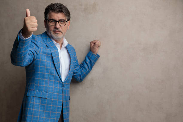istock Positive businessman giving a thumb up and looking forward 1153409817