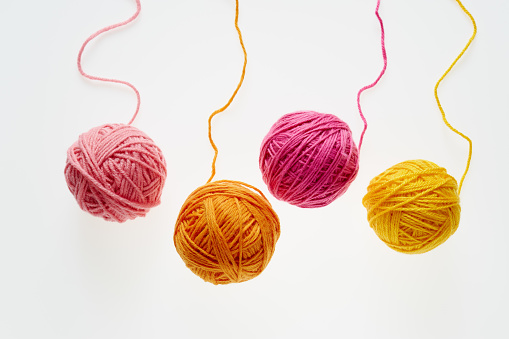 Colorful woolen balls over white background.