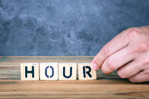 istock Hour - word from wooden letters 1153411078