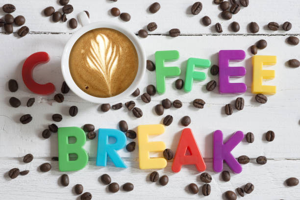 istock Coffee break concept with coffee cup and text from colourful letters on roasted beans 1153411888