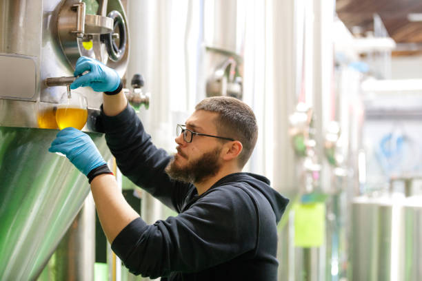istock Pouring beer from fermenting tank 1153413438