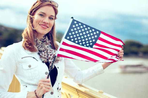 istock Young woman holding USA flag 1153413652