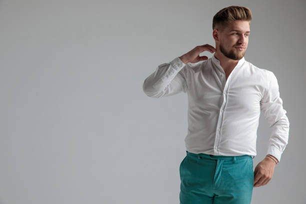 istock Positive man touching his neck and smiling to the side 1153415089