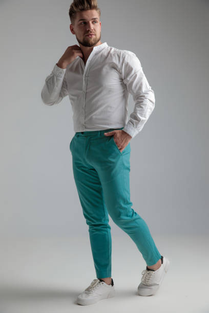 istock Handsome man adjusting his collar and walking to the side 1153415174