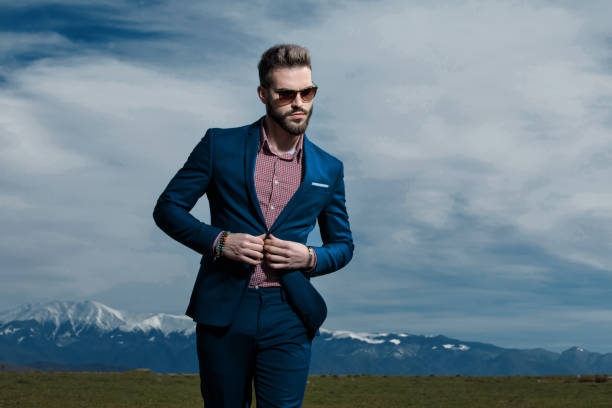 istock Serious looking man adjusting his jacket and walking 1153416591