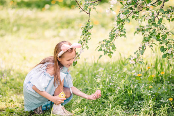 istock Adorable little girl in blooming apple garden on beautiful spring day 1153416607