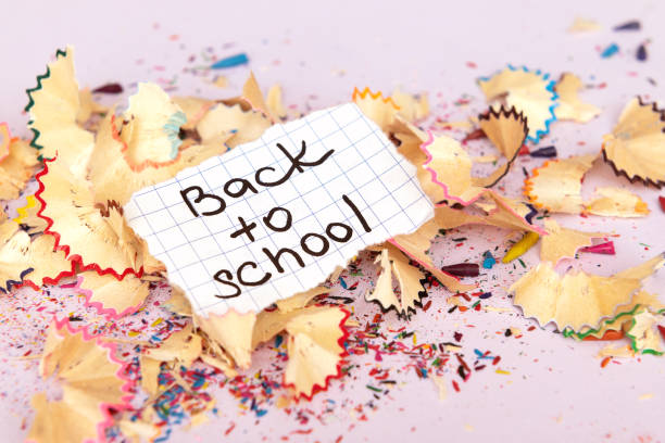 istock Back to school inscription on paper on black background. 1153416927