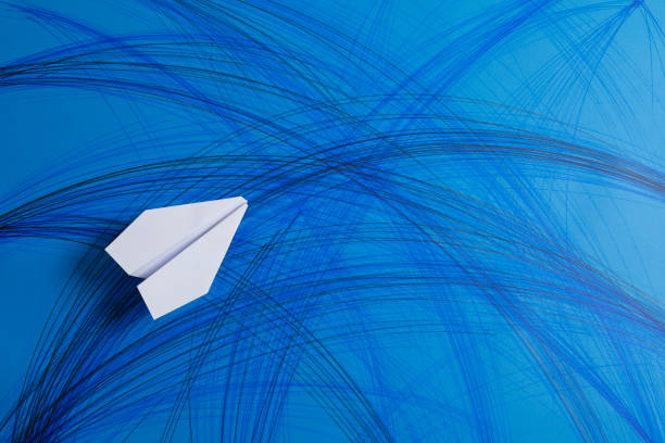 istock White Paper Airplane on painted blue Paper 1153417109