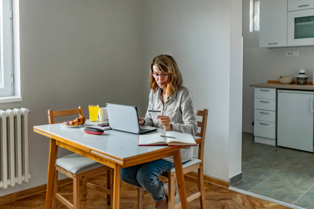 istock Woman paying bills from home 1153419222