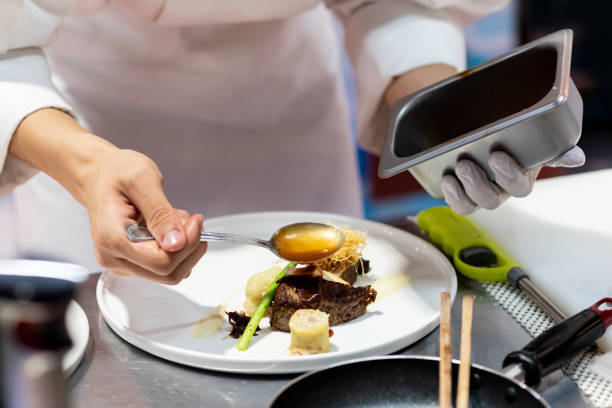 istock Chef preparing food, meal, in the kitchen, chef cooking 1153419548