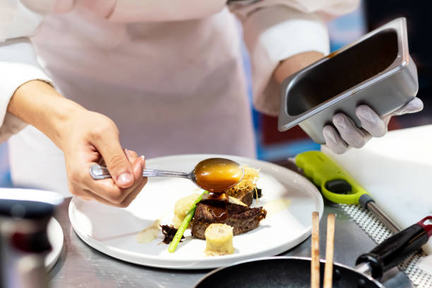 istock Chef preparing food, meal, in the kitchen, chef cooking 1153419549