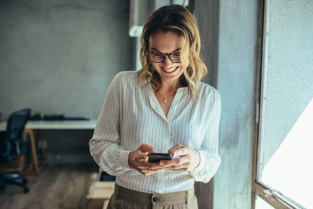 istock Businesswoman using her smart phone in office 1153419575