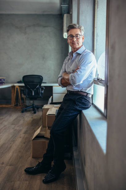 istock Confident businessman at office 1153419643