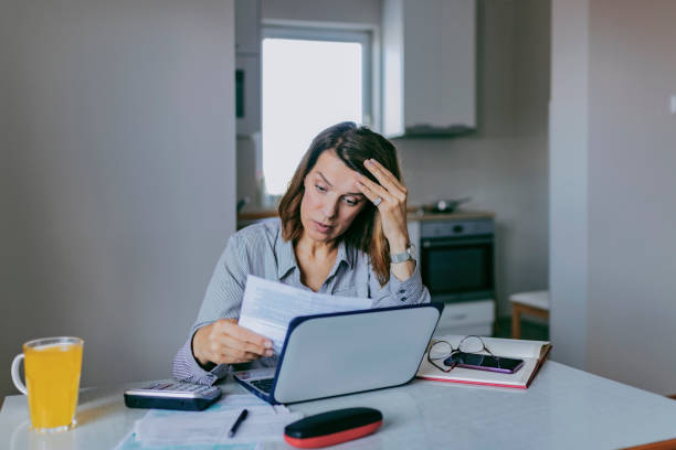 istock Stressed Woman going through Bills, looking worried 1153419844