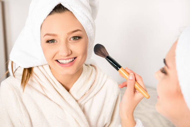 istock Nice young women doing makeup with towels on their heads 1153423035