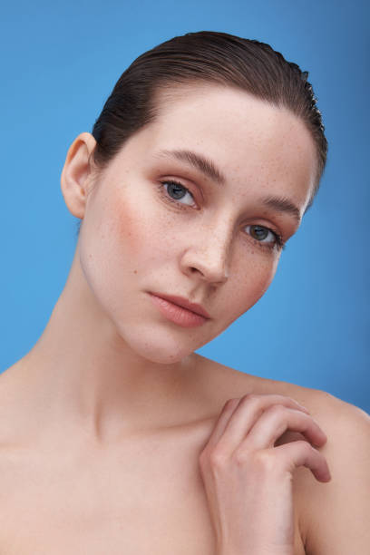istock Pretty tender freckled woman bowing head aside 1153423764