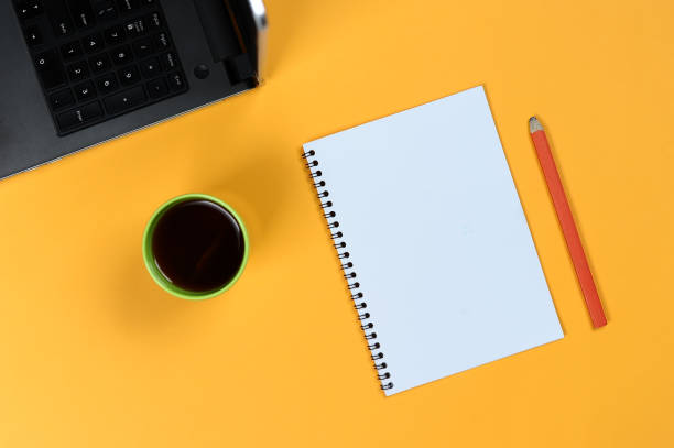 istock Blank notebook page, laptop, coffee cup and pencil. Blank writing pad for ideas and inspiration 1153425581