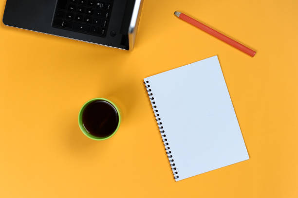 istock Blank notebook page, laptop, coffee cup and pencil. Blank writing pad for ideas and inspiration 1153425935