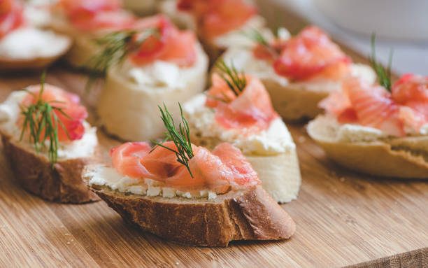 istock Smoked salmon bite sandwich with dill and cream cheese. 1153426926