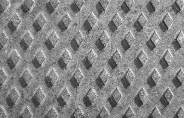 Old rusty drain cover background with diamond pattern.