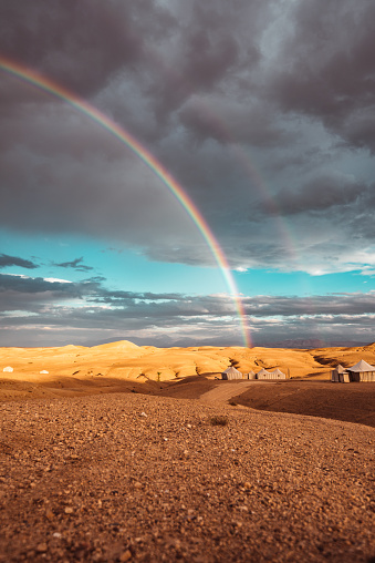 tent in the morocco desert with rainbow