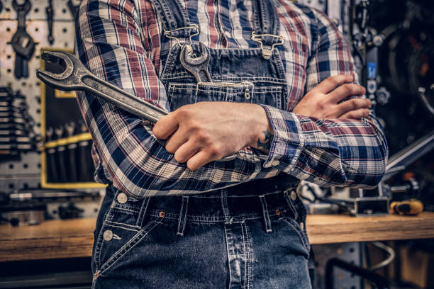 istock Image of nut key in mechanic's arm. 1153433753