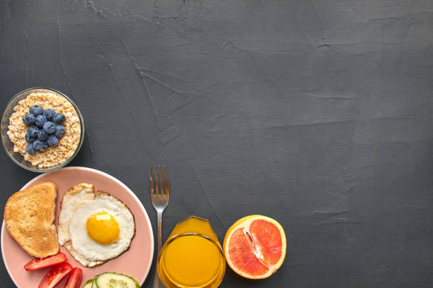 Top view of healthy and delicious breakfast on a black background with copyspace.
