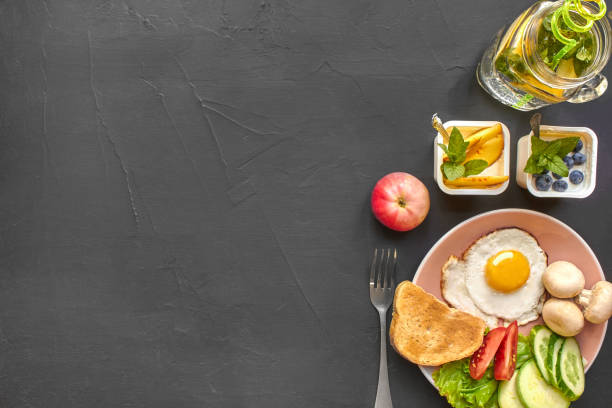 Top view of healthy and delicious breakfast on a black background with copyspace.