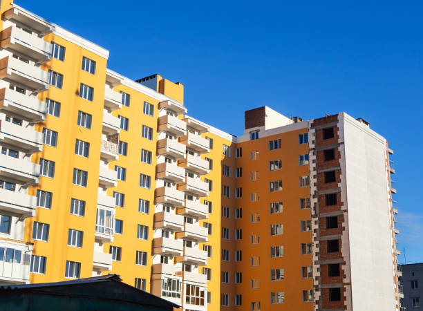 istock Almost finished facade work and insulation of new multistory building under blue sky 1153435076