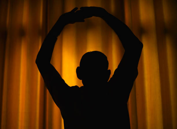 silhouette of a lyng man on a floor look away on white background