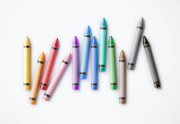 istock Colorful Crayons Scattered On White Background 1153436374