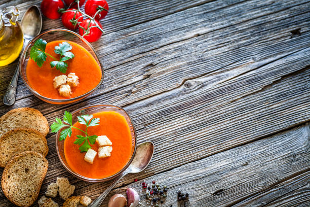 istock Spanish gazpacho in glass bowls on rustic wooden table with copy space 1153436624