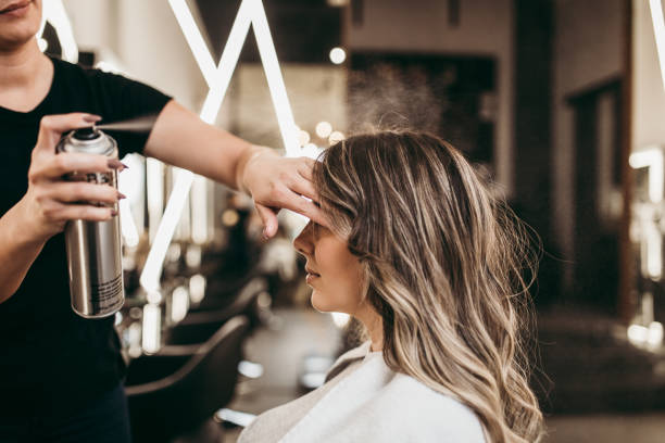 Woman at hair salon Beautiful brunette woman with long hair at the beauty salon getting a hair blowing. Hair salon styling concept. blow drying stock pictures, royalty-free photos & images