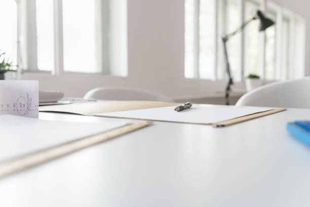 istock Pen lying on a document in an open folder on an office desk 1153439888
