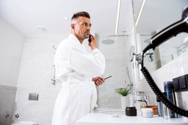 istock Man in front of the mirror working at his hairstyle 1153440545