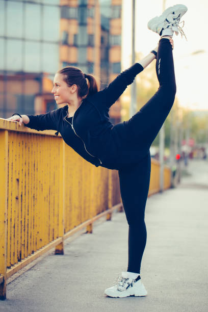 istock Young woman exercising on the bridge 1153440762
