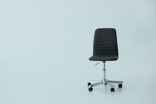luxury black leather office chair on grey with copy space