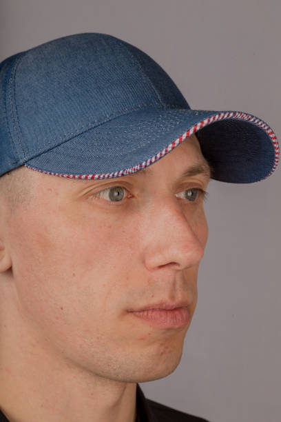 istock Handsome young man in a headdress on a gray background 1153442300