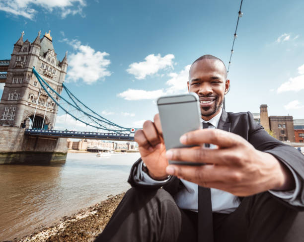 istock businessman take a selfie on tower bridge london 1153442481