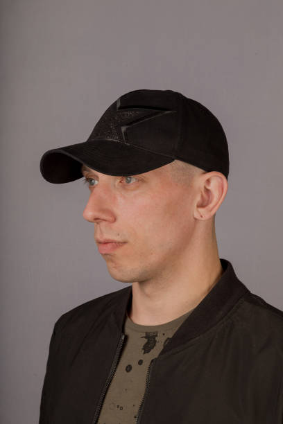 istock Handsome young man in a headdress on a gray background 1153443273