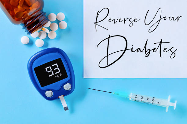 Reverse your diabetes concept. Close up top down view of glucose meter, drug pills, insulin syringe and reverse your diabetes text on blue background Reverse your diabetes concept. Close up top down view of glucose meter, drug pills, insulin syringe and reverse your diabetes text on blue background sugar control stock pictures, royalty-free photos & images