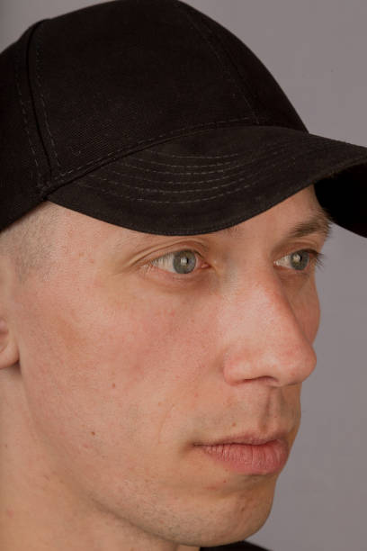 istock Handsome young man in a headdress on a gray background 1153443685