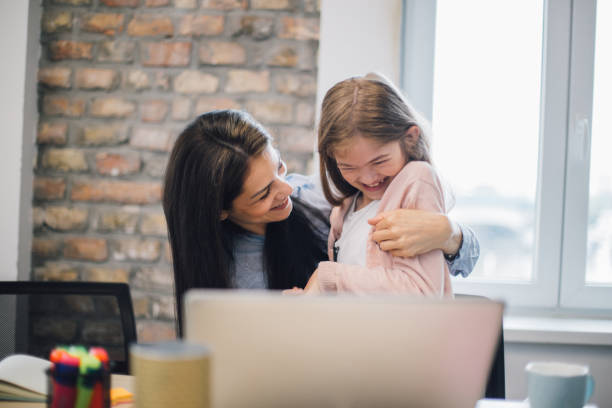 istock Woman embracing her daughter at office 1153443982