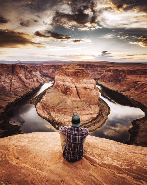 istock man resting at horseshoe bend in usa 1153445034